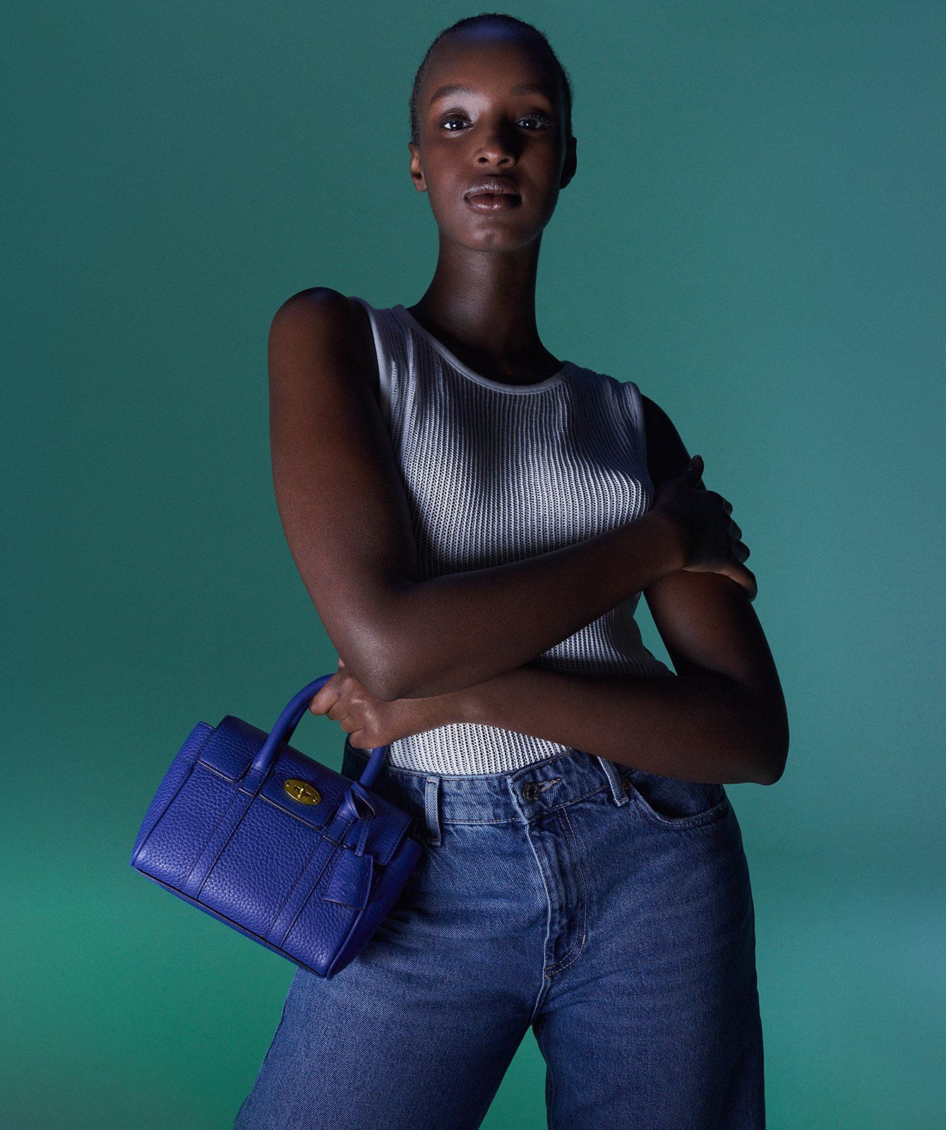 Model holding the Mini Bayswater bag in Pigment Blue